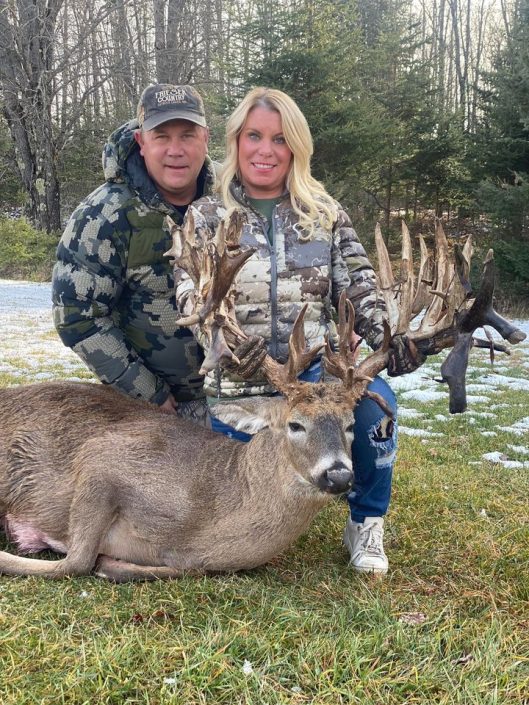 man and woman with buck