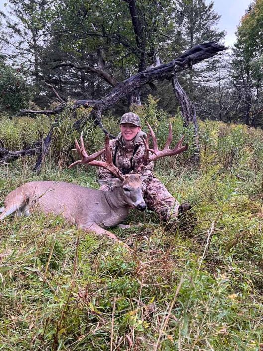 A hunter with a whitetail deer 